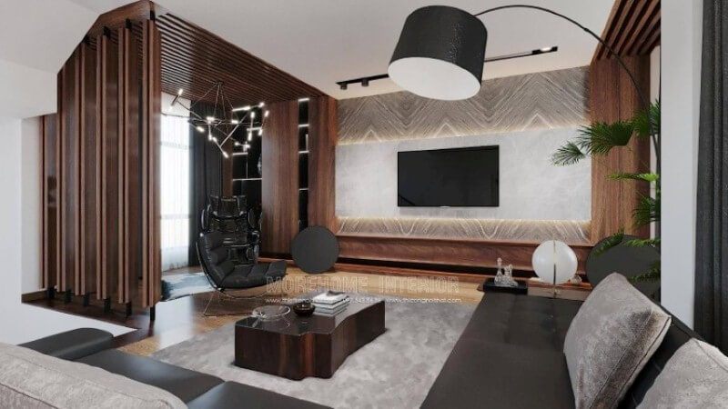 Là một trong những mẫu thiết kế nội thất phòng khách biệt thự sang trong được thiết kế theo lối hiện đại nhưng lại sử dụng chất liệu gỗ làm chủ đạo đã tạo nên vẻ đẹp độc đáo, mới lạ trong Vinhomes Imperia Hải Phòng. Gỗ được biến hóa đa dạng nhưng lại mang tính liền mạch, từ chất liệu làm kệ trang trí, gỗ ốp tường, tạo điểm nhấn đến kệ trang trí. Tuy nhiên không làm cho không gian bị trầm, bởi sự kết hợp khéo léo khi sử dụng chất liệu đá ốp tường có độ bóng sang cùng gam màu tương phản, kết hợp cùng màu đơn sắc trần thạch cao đã làm không gian như trở thành bức tranh hài hòa nhưng lại cuốn hút không ngờ.